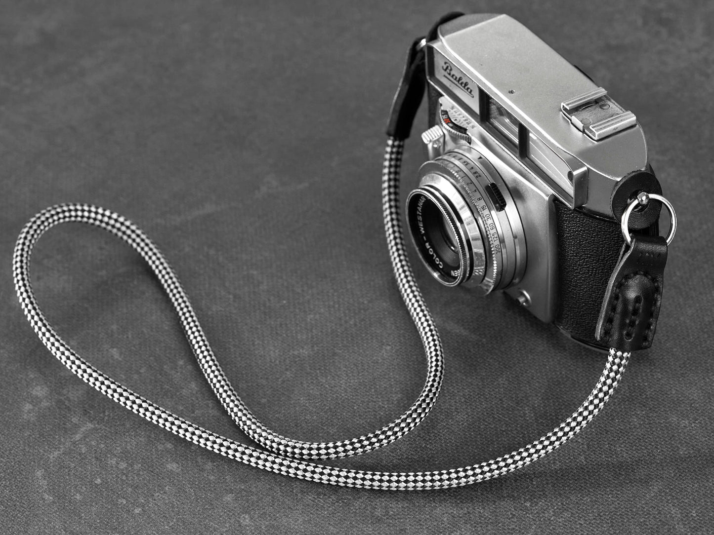 Audrey rope camera strap handcrafted in Western Australia showing checkered rope and black leather ends.