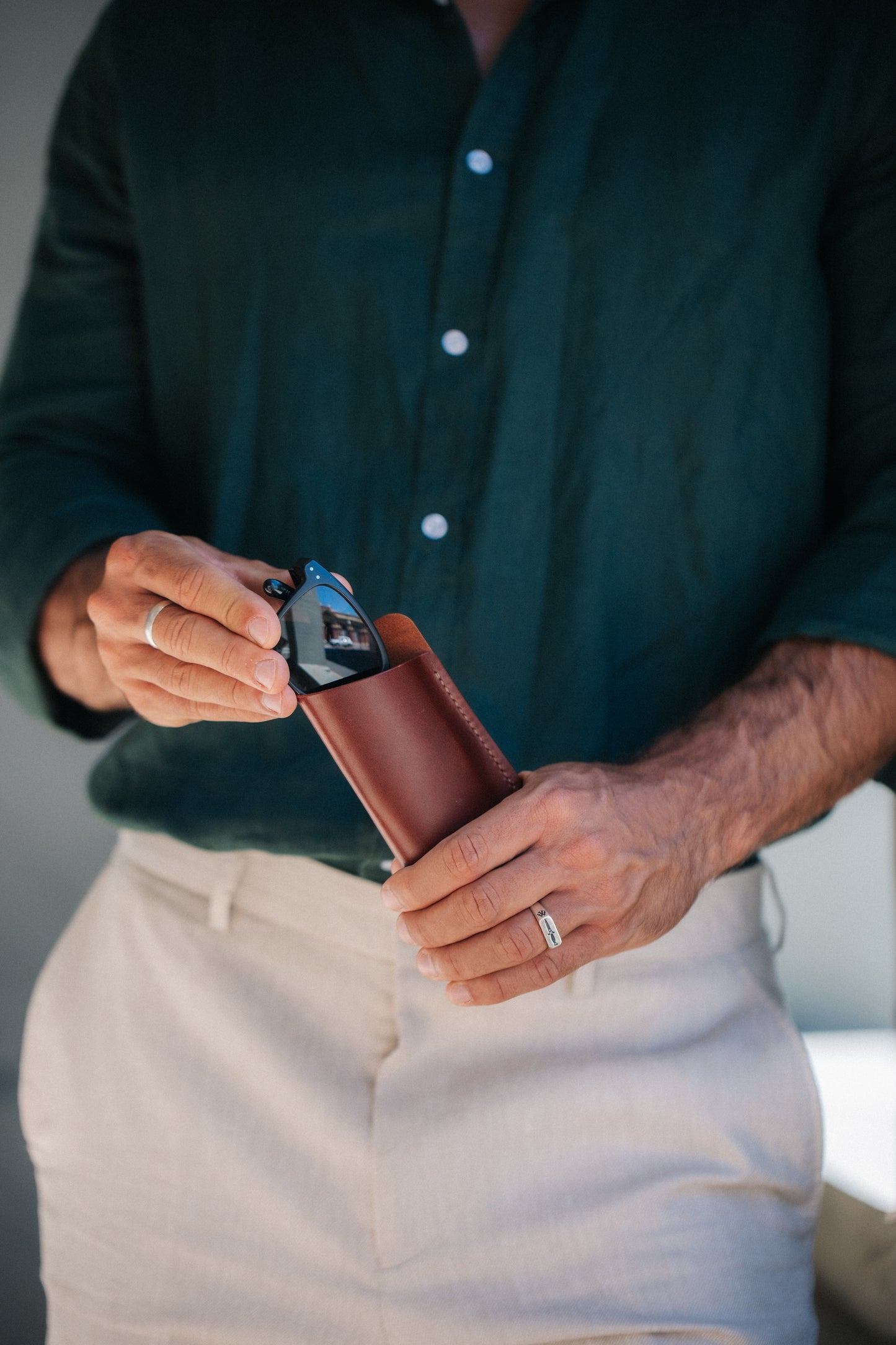 Henry and Wilde minimal Tuscan leather glasses sleeve with reading glasses partly inserted.