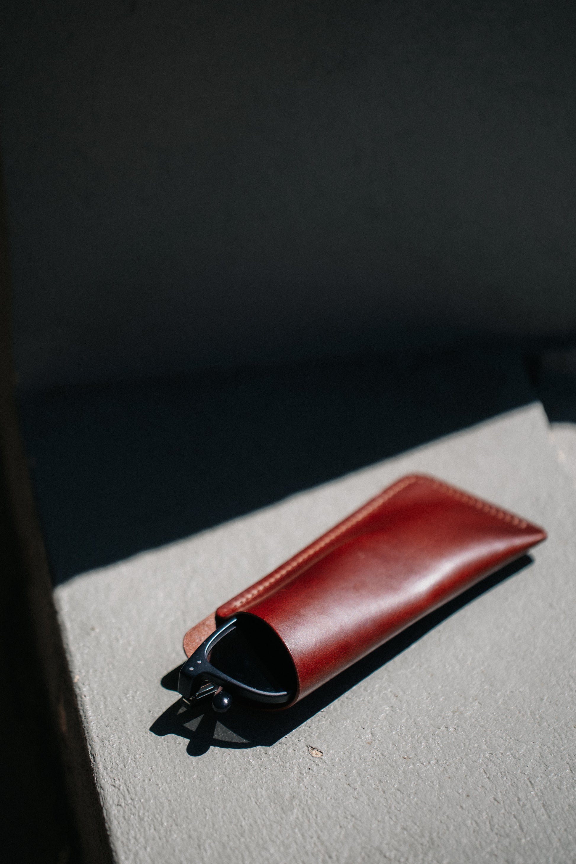 Henry and Wilde minimal Italian leather glasses sleeve with reading glasses partly inserted.