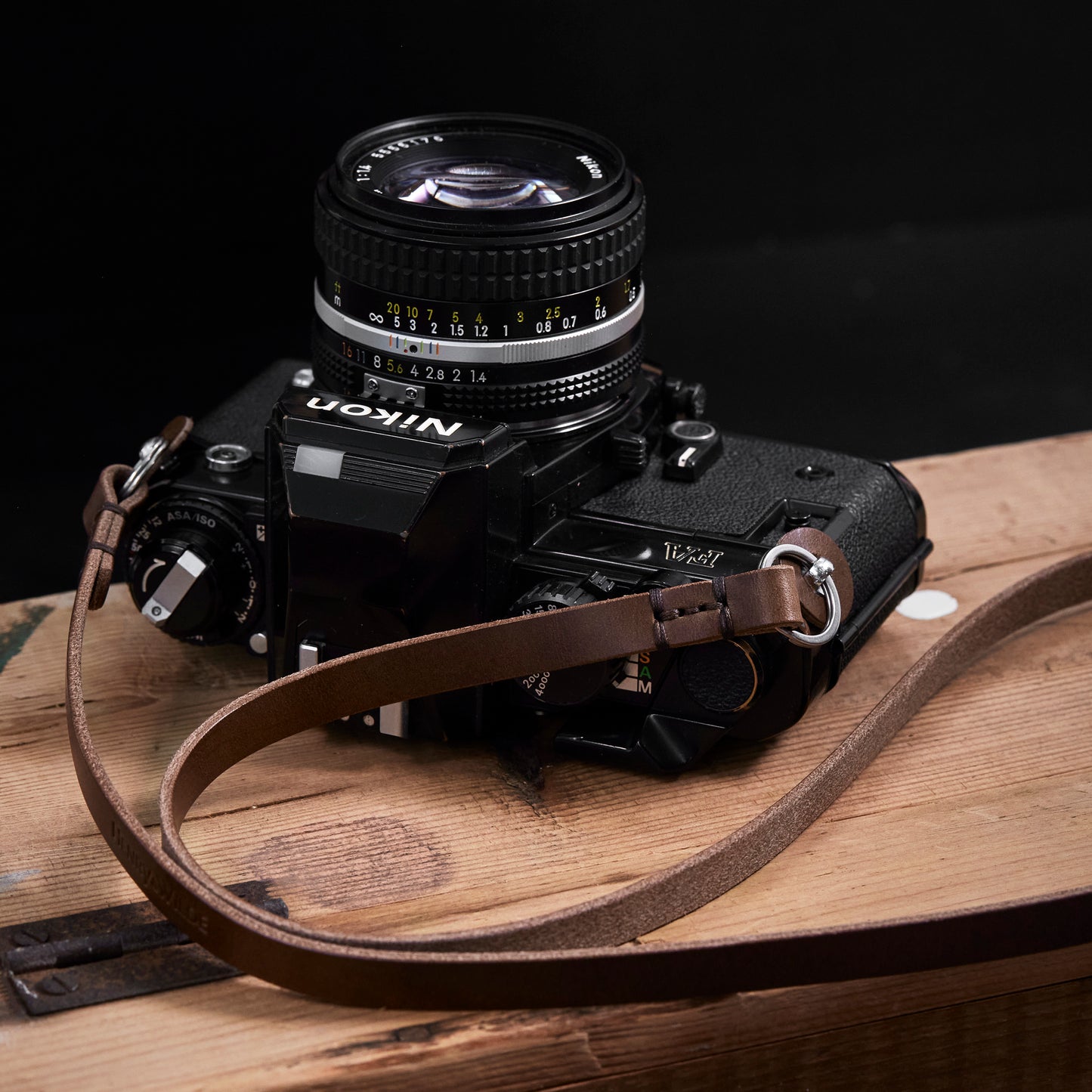 Close up view of the Vincent minimal full grain Italian leather camera strap showing the hand sewn waxed thread detail