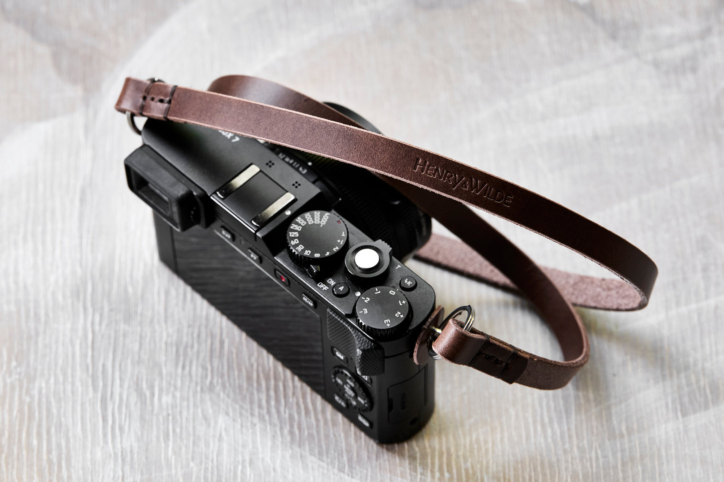 Henry and Wilde Vincent minimal 10mm leather camera strap attached to a D-Lux 7 camera body.